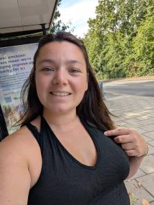lady wearing black top and smiling