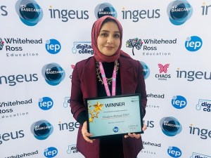lady in headscarf holding winner award